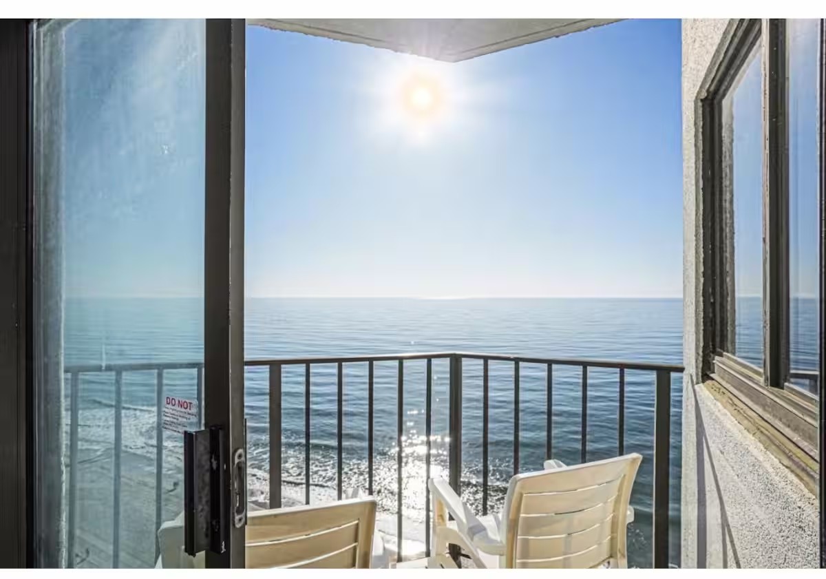 Private balcony with chairs overlooking the shoreline