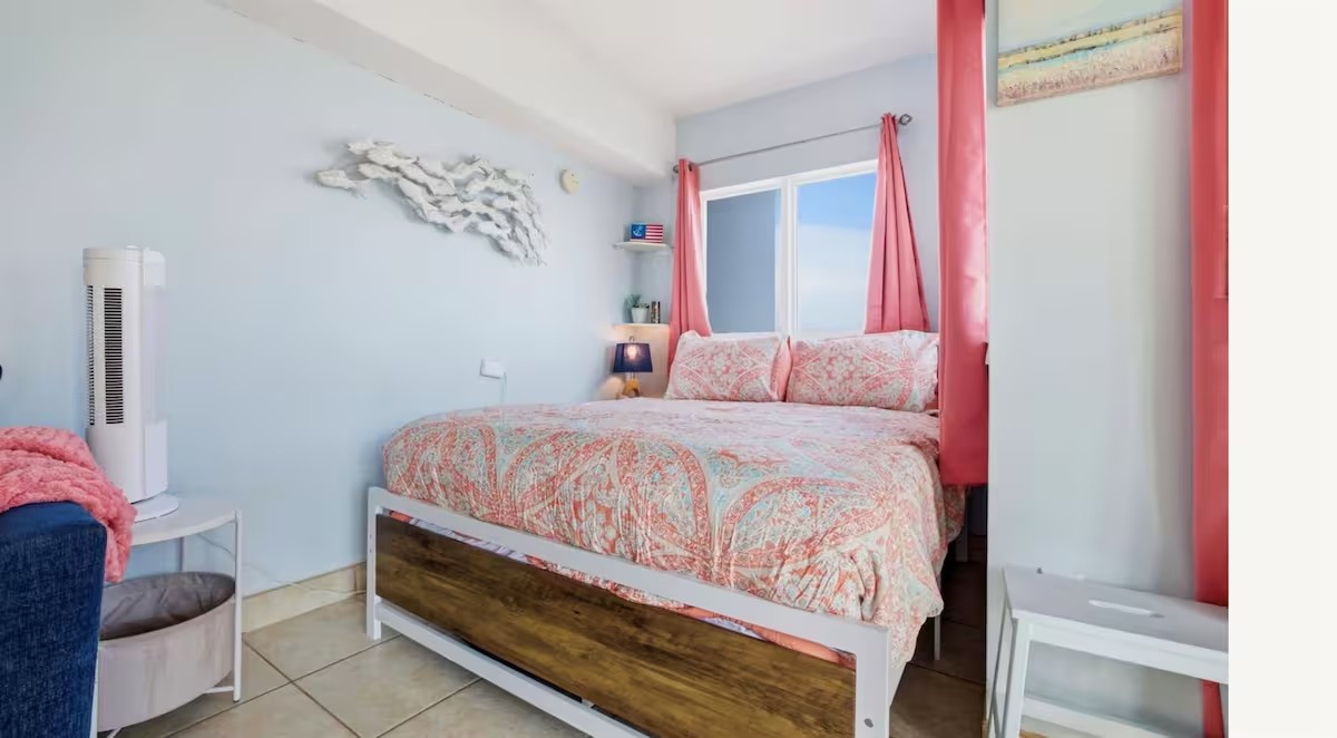 Queen bed with soft coastal linens